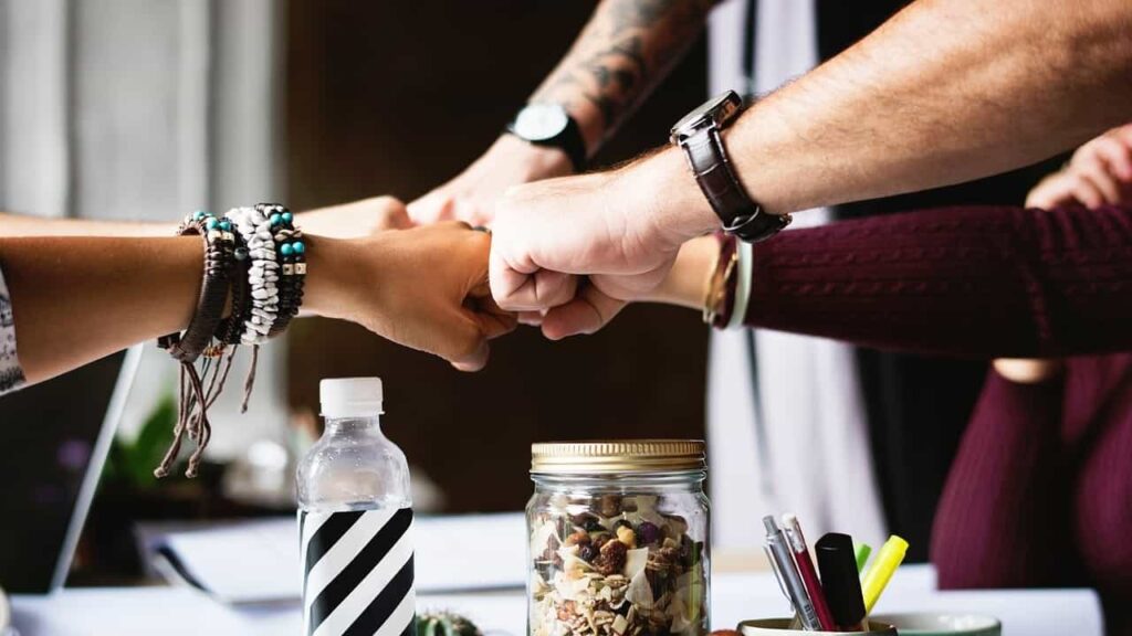 People with hands together to illustrate a blog post about LinkedIn groups.