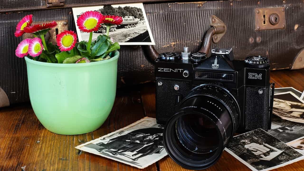Old camera and photos to illustrate blog post about investing in a website vs social media.