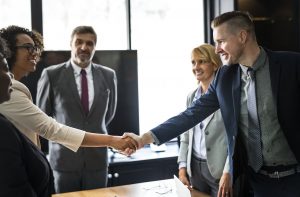 People shaking hands to illustrate the goal of retaining customers.