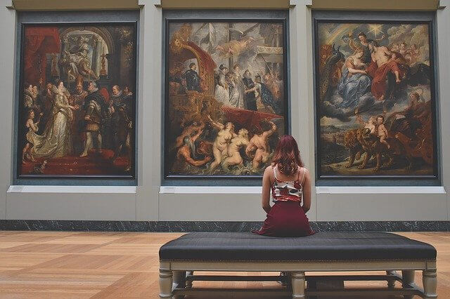 Image of a woman looking at art to illustrate content imagery tools.