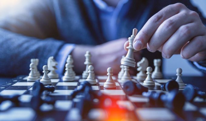 Person playing chess to illustrate how to develop a content marketing strategy.