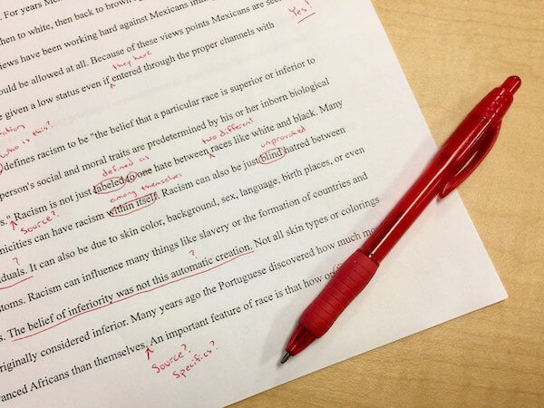 Paper with red editing notations on it to illustrate the editing process.