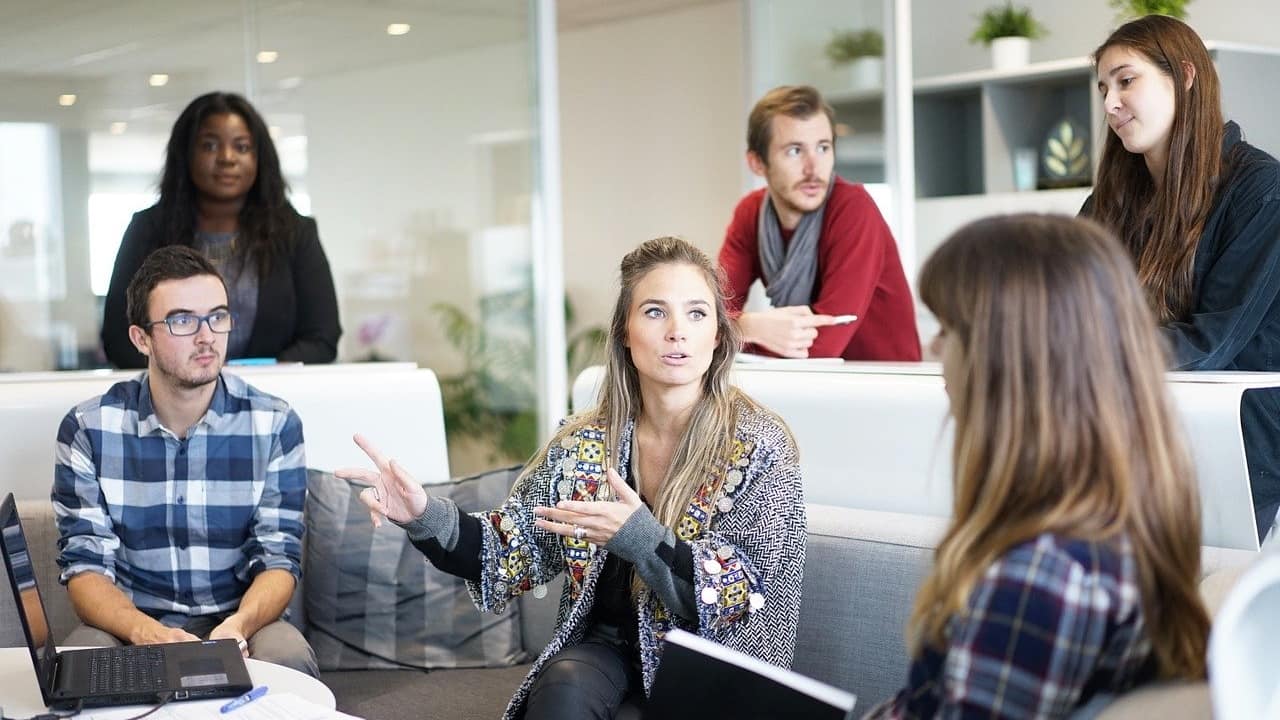Image of people conducting a meeting, presumably discussing buyer persona questions.
